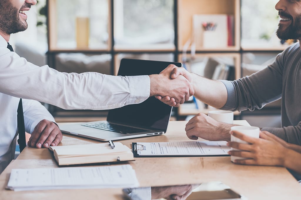 handshake-over-desk